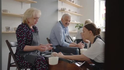 People Learning Pottery Techniques in Ceramic Studio