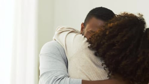Man and Woman Share Loving Embrace Indoors