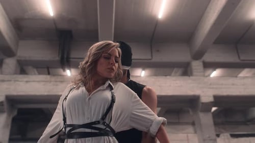 Woman with Blonde Hair embraced by Man in Urban Setting