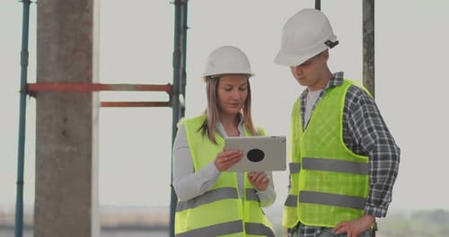 Portrait of Construction Engineers Working on Building Site