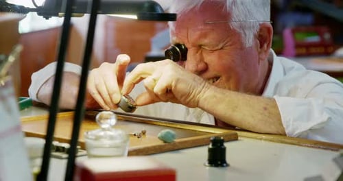 Senior Jeweler Working on Ring in Workshop