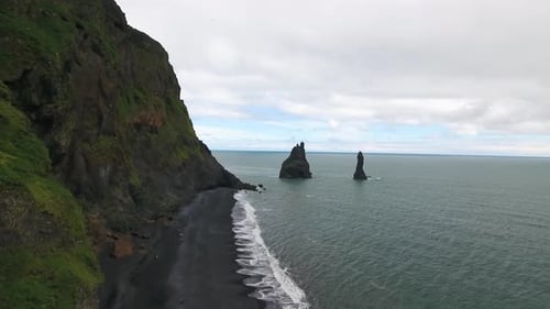 Flying over the famous black sand beach near Vik i Myrdal town in Iceland