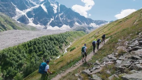 Active tourists go to mountains on a sunny day