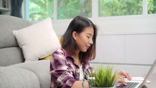 Woman Working on Laptop at Home