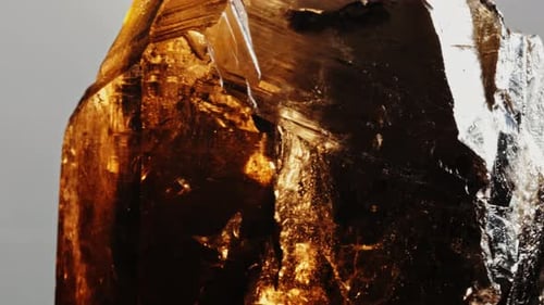 Smoky Quartz Mineral Rock Gem Stone Quartz Geology Specimen, Quartz Rotates on a Grey Background