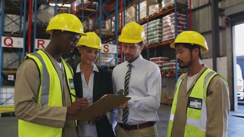 Two managers and two workers meeting in a warehouse 4k