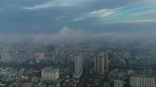 Early morning urban drone flight orbit around high rise buildings and major roads and bridge with he