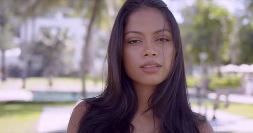 Attractive Young Woman Posing in Tropical Park
