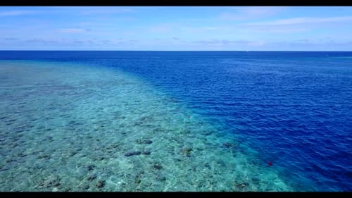 Aerial top down landscape of relaxing coast beach adventure by blue green water and white sandy back