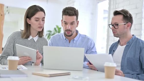 Young Adults Collaborating in Office Environment