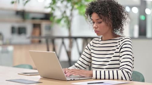 African Woman Working on Laptop in Office