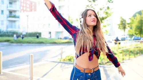 Woman Dancing to Music in Urban Setting