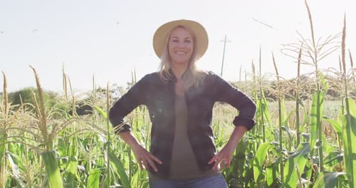Video of happy caucasian woman standing in field on sunny day