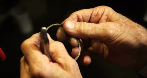 Goldsmith manufacturing jewellery in workshop