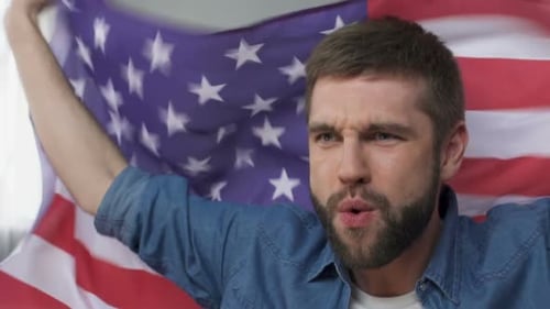Bearded Man Holding American Flag Indoors, Cheering