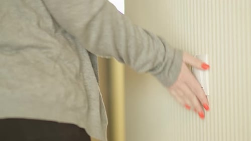 Mulher sai da sala e apaga a luz