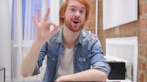 Young Adult Giving Ok Hand Gesture in an Indoor Setting
