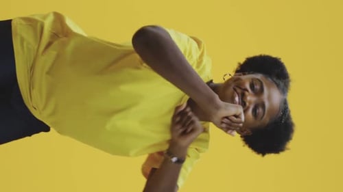 Woman Dancing Energetically in Vertical Format Video