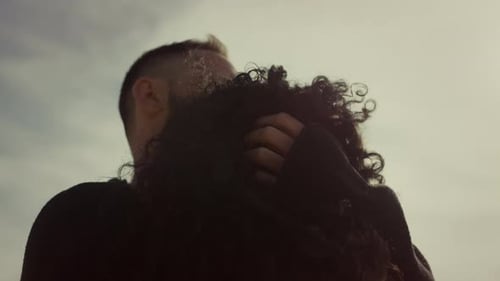 Romantic Couple Embrace on Cloudy Day