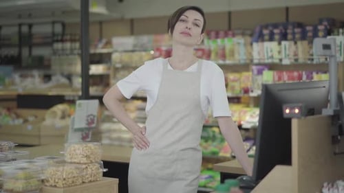 Woman Smiling Posing in a Supermarket at Checkout