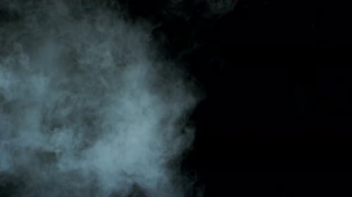 White Smoke Billowing Against Black Background