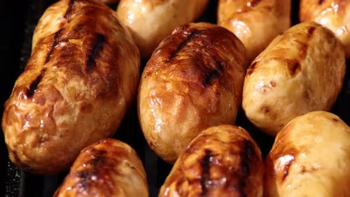 Cooking new potato in charcoal grill