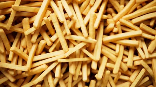 Loopable footage of the endless french fries pile. Fast food. Tasty chips. 4k HD