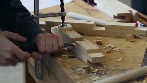 Woodworker Chiseling a Notch Out of Wood