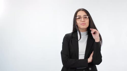 Confident Woman in Black Blazer Standing Indoors