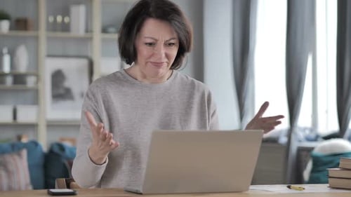 Frustrated Woman Reacts to Laptop at Home