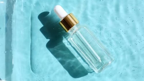 Dropper Bottle on Light Blue Surface