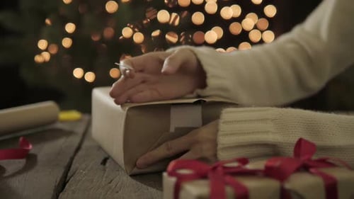 Wrapping Christmas Present at Cozy Table