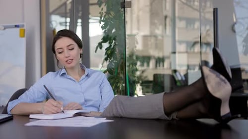 Young Girl Office Worker Sitting At The Table