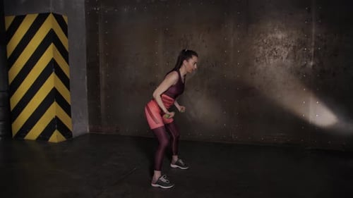 Athletic Beautiful Woman Doing Exercises in the Gym