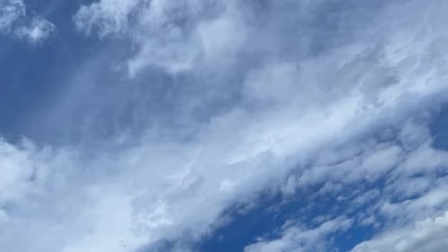 Clouds Billowing Across a Bright Blue Sky