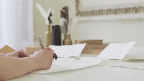 Person Writes with Quill Pen Indoors