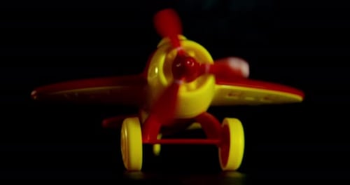 Toy Airplane Propeller Spinning in Dark Room