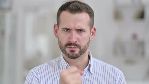 Angry Man Speaking and Gesturing Indoors