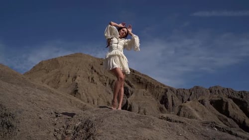 Woman Modeling White Dress in Desert Landscape