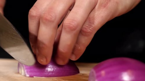 Slicing a Red Onion on a Cutting Board