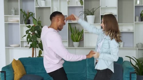 Couple Dancing and Celebrating Together in Living Room