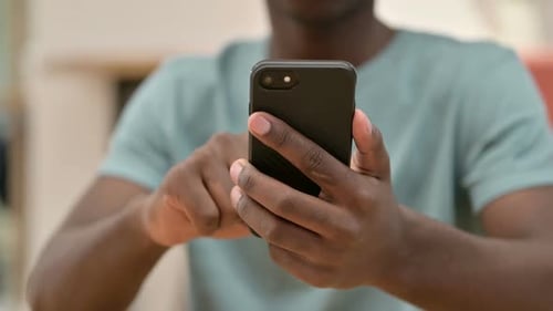 Adult Using Black Cellular Device in Close Up