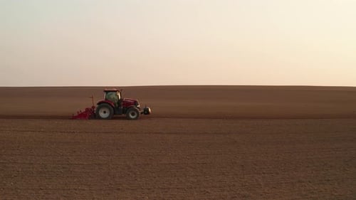 Tractor Prepares the Field for Sowing