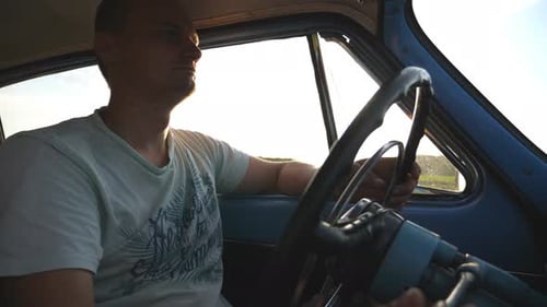 Man Driving Vintage Car on Sunny Rural Road