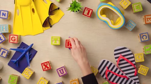 Woman Hand Arranging Wooden Cubes with Word TRIP Top View