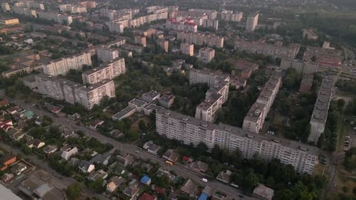 Drone Flying Over Apartment Buildings and Street in Small European City at Summer Evening