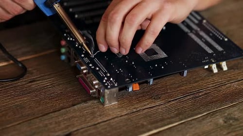 Soldering Repair to a Computer Motherboard Close Up