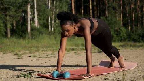 Fit Woman Doing Mountain Climbers in Forest