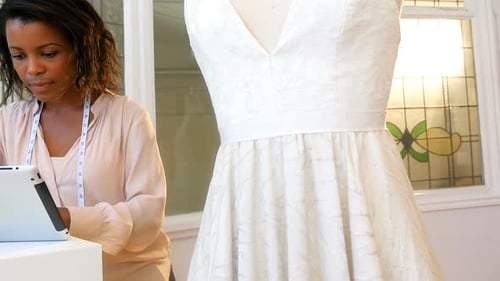 Woman Designs Dress Using Tablet Indoors