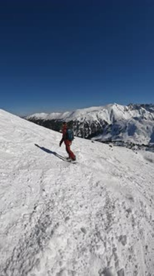 Snowboarding Down a Mountain on a Sunny Day